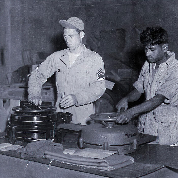Sgt. M. L. Mitchell, Texarkana, Texas, teaches Indian assistant how to run stencil machines. - U.S. Air Force, 1944